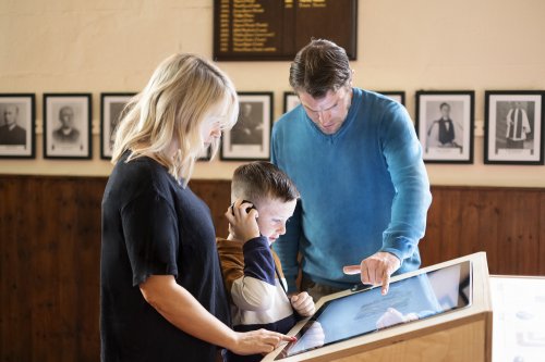 A family looking at an interactive display.